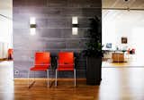 The bubble-infused clear glass diffuses light in the most beautiful way on this Tonic Sconce. #lighting #sconce #office #commercial