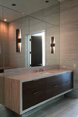 Mountable on the wall or the mirror, the Icicle Wand Sconce comes in seven metal finish options. Can be configured with either clear or etched glass. LED and ADA compliant. Designed by Tom Nahabedian. Interior design by Laura Lee Clark Interiors. As seen in the award winning Chicago Alinea restaurant. #sconce #lighting #modernlighting #lightingdesign #bathroomsconce #bathroommirror