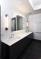 This interior wall sconce by Boyd Lighting, can be mounted on the wall with rectangular back plates or mounted directly onto a mirror, (without back plates), for the illusion of a floating light source. The Iwall Sconce, with its internally fluted diffuser, is the perfect fixture for residential bathrooms or dressing rooms, and is priced well for commercial and hospitality spaces. ADA compliant. Available in two metal finish options and three sizes. #sconce #bathroomsconce #lighting