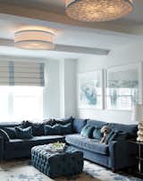This flush mount ceiling fixture by Boyd Lighting is a sophisticated update on the ancient South American handcrafted technique called Filigrana in which small metal pieces are combined to create a large spiral pattern. This flushmount and its pendant cousin won the Best of Year award from Interior Design magazine. Available in light or dark colorway options. Interior design by Carolyn Rebuffel Designs. #livingroom #livingroomlighting #flushmount #flushmountceilingfixture #drumshade