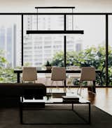 The linear T-Light Pendant features parallel pieces of extruded aluminum that hang from two stems and sandwich a ¾” thick piece of etched, water white glass and form an upside down “T”. Two strips of 3000˚K LEDs provide warm up and down-light and are wired as dual circuits, which allows each light source to be dimmed separately. Once hung, each of the two stems can be adjusted independently to level the pendant. The T-Light comes in a myriad of standard powder coat finish options:  Cinnamon Bronze; Rubbed Bronze; Silver Fog; Black Granite; Gossamer Aluminum; Gloss White; Golden Gate Orange; and Coffee Bean. 12 specialty powder coat options available. Available in 5’, 6’ and 7’ lengths. #lighting #commerciallighting #conferenceroom #conferenceroomlighting #pendant #LED #office #officelighting #architecturallighting