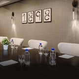 As seen in this Charmant Hotel meeting room,  the Icicle Drop Sconce makes a subtle yet sexy statement and provides a glowing, ambient light. LED. Available in six metal finish options and six cord color options. Can be configured with either clear or etched glass. ADA version available. From Chicago architect, Tom Nahabedian, for Boyd Lighting. #lighting #commerciallighting #conferenceroom #conferenceroomlighting #sconce #wallsconce #architecturallighting #LED #meetingroom #meetingroomlighting #office #officelighting