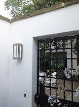 The exterior, LED Phantom wall sconce by Sherry Williamson for Boyd Lighting is a stunning addition to loggias, hallways, gates, entrances and walkways for both residential and commercial or hospitality applications. The stay-clean sealed box of this sconce is mysteriously lit by an LED panel hidden in the base that makes its clean lines glow. Fixture includes a practical "find-your-keys" downlight. Features a mirrored inside back panel and water white glass front and side diffusers. Available in four metal finish options. #lighting #exteriorlighting #outdoorlighting #sconce #exteriorsconce #mirroredsconce #entry #entryway #entrylighting #backyard #backyardlighting #BoydLighting #lightingdesign