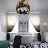 This surprising LED Alhambra wall sconce by Brooklyn artist, Fiyel Levant, for Boyd Lighting is a fresh take on middle-eastern motifs. Arabesques and curlicues cover the front of the Alhambra Sconce, yet as if by magic, a different pattern emerges when the fixture is lit. It provides soft up light and down light. Comes in a creamy white solid surface polymer with one of four metal finish options. ADA compliant. Shown here in the 2015 San Francisco Decorator Showcase bathroom designed by Tineke Triggs. #bathroom #lighting #bathroomlighting #sconce #bathroomsconce #boydlighting #lightingdesign