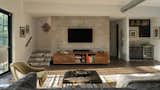 Inside, exposed duct work and block accent walls maintain the home's urban appeal. The home feels relaxed, inviting and warm despite its traditionally industrial features.