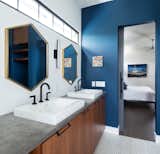 Bold colors, geometric design elements and warm woods give grand appeal to the home's private spaces. Here, the master bathroom is bright and bold, but relaxed and functional.
