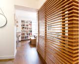 Teak screen offers the office space some much needed privacy while allowing for natural daylight