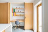 Tucked in a small workspace, just behind the kitchen pantry's pivot pocket doors