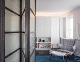 12' custom blackened steel and industrial glass folding door flexes between living room and guest bedroom