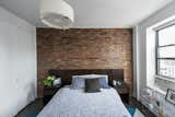 Masterbedroom with the  exposed brick and wall of closets