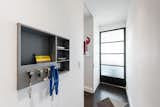Entry: built in niche for easy access, soft glowing light into the living room through the salvaged industrial glass 