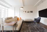 Spacious, brightly lit living room with beamed ceillng
