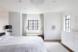Masterbedroom with silk accent wallcovering balanced with neutral white walls and silk curtains