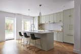 Sage kitchen with bright new windows and herringbone white oak floors