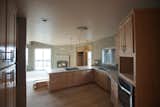 A modern kitchen that opens up into the living area  Photo 4 of 9 in Round House in Wine Country by Deltec Homes
