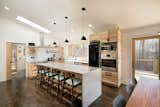 Kitchen, Concrete Counter, Dark Hardwood Floor, Wood Cabinet, and Pendant Lighting  Photo 7 of 9 in Net Zero Energy Home by Deltec Homes