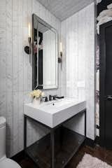 Porcelain 12x32" wall tile adds interest to a small vanity area