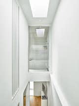 A vertiginously perched shower overlooks a private stair to the master suite. 