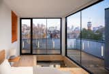 Bedroom, Medium Hardwood Floor, and Accent Lighting Bedroom mezzanine with view over city.    Photo 8 of 15 in Black Metal Steels the Show at This Renovated Live/Work Space in Toronto from House Studio