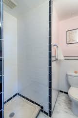 The small 3/4 ensuite bath in the primary bedroom.