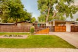 From the street, large trees provide shade to the private courtyard in the summer. A unique remote-controlled gate has been added to the house’s original carport. A new address monument matches the angle of the house’s roof.