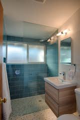 The renovated master bath. A tub has been removed to make room for a new glass shower.