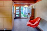 A small dining room adjacent to the kitchen has a window wall to the backyard, and is an extension of the adjacent U-shaped kitchen.
