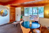 While interior walls were treated with wood paneling, exterior walls are comprised of exposed pumice block with red brick sills and wall base as accents. Doors on either side of the fixed-pane windows open to louvres for cross ventilation, when desired.