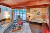 The living space was expanded into the original garage and the garage door was replaced by a window wall. The expansion, which included an addition behind the house was also designed by Edward Hawkins. The same simple architectural language was extended into this space, including wall paneling, stained tongue-and-groove ceilings and exposed beams.