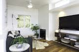 Living Room, Gas Burning Fireplace, Ceiling Lighting, Light Hardwood Floor, Accent Lighting, End Tables, Sofa, Coffee Tables, and Bookcase Family Room  Photo 20 of 27 in The Live Oak House by Mandy Cheng Design