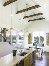 Kitchen, Pendant Lighting, Dishwasher, Undermount Sink, Wood Cabinet, Light Hardwood Floor, Wine Cooler, and Concrete Counter Kitchen and Dining  Photo 16 of 27 in The Live Oak House by Mandy Cheng Design