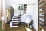 Hallway and Light Hardwood Floor Entrance  Photo 12 of 27 in The Live Oak House by Mandy Cheng Design