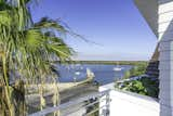 Outdoor, Trees, Rooftop, Metal Fences, Wall, and Wood Patio, Porch, Deck Rooftop balcony  Photo 5 of 27 in The Live Oak House by Mandy Cheng Design