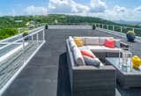 The rooftop deck of this modern home in Austin uses Feeney CableRail to keep the view of the city's skyline unobstructed.