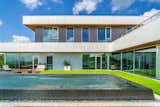 The clean lines of this modern home in the Austin Hill Country fit perfectly with the infinity edge pool, which is inlaid with custom imported tile.