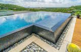 $150,000 worth of imported tile covers this infinity edge pool, the one-of-a-kind tile changes color in different light. 