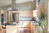 Kitchen, Refrigerator, Wood Cabinet, Wall Oven, Dishwasher, Cooktops, Microwave, Range Hood, Granite Counter, Light Hardwood Floor, Ceiling Lighting, Accent Lighting, Rug Floor, Undermount Sink, and Porcelain Tile Backsplashe  Photo 6 of 13 in Yellow Birches by Cushman Design Group