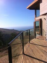 Glass Railing Installation in Jenner, CA.  Custom Powder Coat Railing with a segmented curve.  Providing an amazing view of the Pacific Ocean

