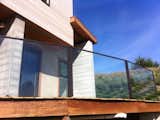 Glass Railing Installation in Jenner, CA.  Custom Powder Coat Railing with a segmented curve.  Providing an amazing view of the Pacific O