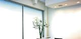
On the top two floors of a six-story early 20th century building in downtown San Francisco, Jensen & Macy Architects created a unified office space for a graphic design firm.  At the center of the plan, two bays of floor slab were removed to provide a direct visual connection between the floors and a dramatic double-height space at the reception area.  The approach is restrained, disinterested and quiet;  realized in a simple palette of drywall, walnut, steel, glass and integrally colored concrete.  At selected locations, existing finishers were removed to reveal the original rough brick and concrete surfaces underneath.