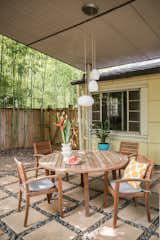 The current homeowners added the concrete and beach pebble patio, sheltered by an overhang clad in interior wall panels salvaged from another Lustron.