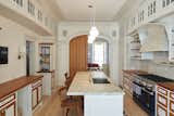 Kitchen designed by architect Louis Mackall. Cabinet fabrication by James Schriber Furniture. Tile backsplash by Mosaic House in NY, specializing in Moroccan Tiles. 

Architect Louis Mackall designed two archways, with custom arched pocket doors from Breakfast Woodworks for the parlor opening.