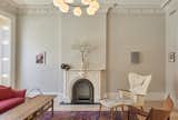 Parlor: A Vilhelm Lauritzen hangs above a Vintage Moroccan rug from Breuckelen Berber.  A Finn Juhl Chieftain Chair alongside a Mama Bear Chair; reupholstered and paired with a matching ottoman in Hella Jongerius fabric sit next to a Hans Wegner coffee table. 

Ceiling decoration is original – parts of it replicated by Absolute Plastering in Brooklyn.