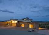 "We chose some pretty unique materials for the La Tierra Nueva, informed by Northern New Mexico’s traditional building materials, such as mud plastered, site cast adobe and corrugated metal in addition to colors and textures found on the site. The house incorporates zinc siding, selected for its color connection to the site. We used cladding for the walls, and corrugated roofing. The glass was meant to open the home up toe the environment. Finally, the rammed earth building technique had a strong connection to the site itself. " Graham Hogan, AIA, LEED of Studio GP LLC