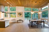 Floor-to-ceiling Zola windows in the main living area, gives an expansive view of the surrounding Northwest forest. The tops of these windows reveal the interior cedar clad and the up-swept soffits on the home’s exterior, creating a floating ceiling effect. Slatted spruce wood fly-overs break up the vertical areas of the great room and define separate areas that would otherwise feel like an overwhelmingly expansive space.