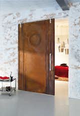Wood barn door utilizing a modern barn door hardware as an entrace to a bedroom. 