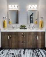A porcelain tile with an abstract "painted wood" look was used on the bathroom floor for a hint of urban rustic. 
