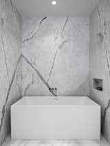 Soaking tub by Wet Style and custom stone niche at the Master Bathroom.