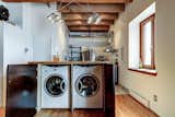Laundry Room, Wood Counter, Wood Cabinet, and Concealed Secret laundry area  Photo 2 of 8 in Old Montreal Studio by Big Panda Design