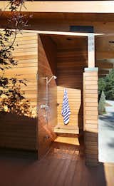 Outdoor shower with cedar clad door to blend with siding